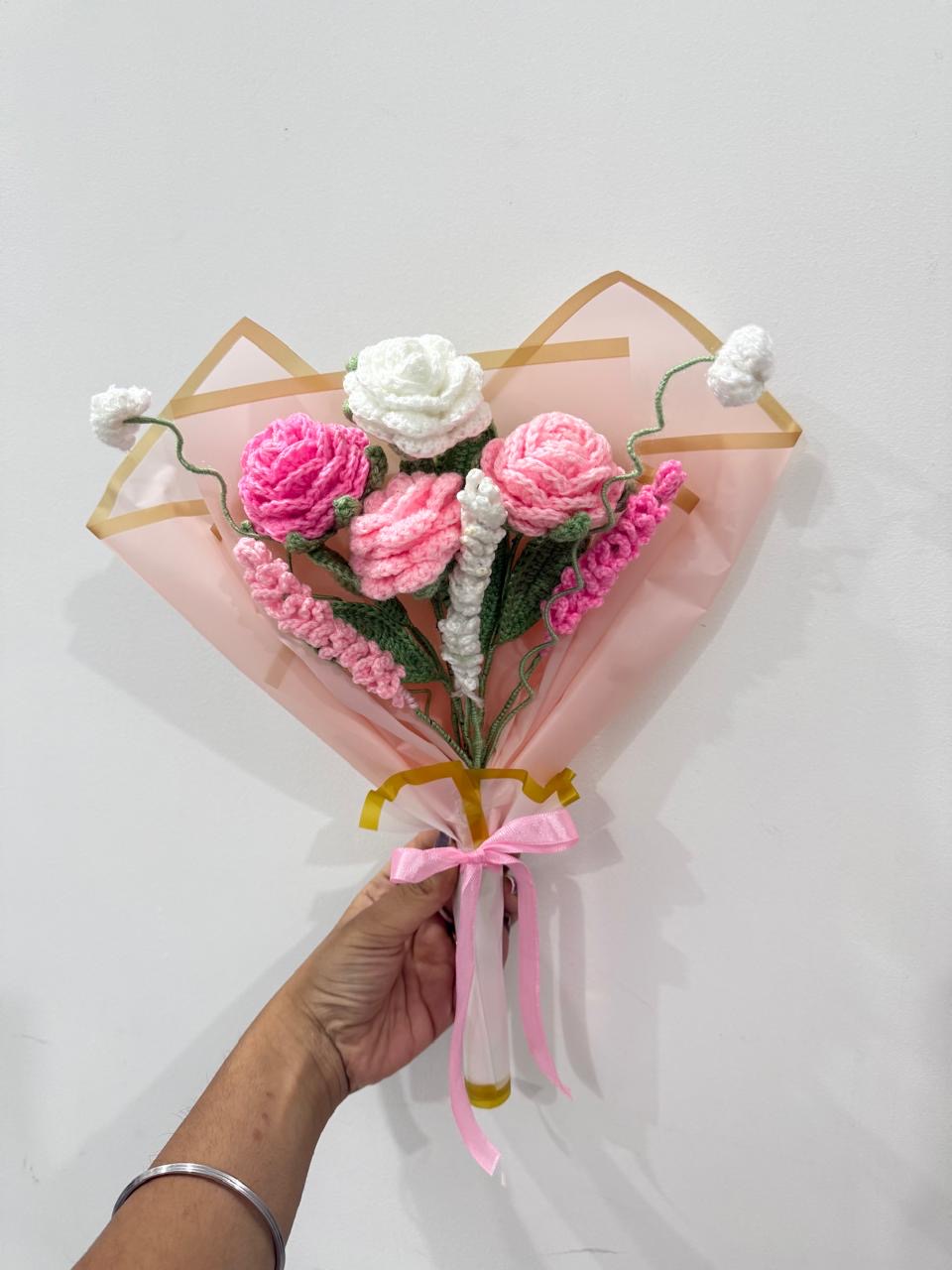 Handmade crochet rose bouquet in pink and white, wrapped in blush paper with a pink bow